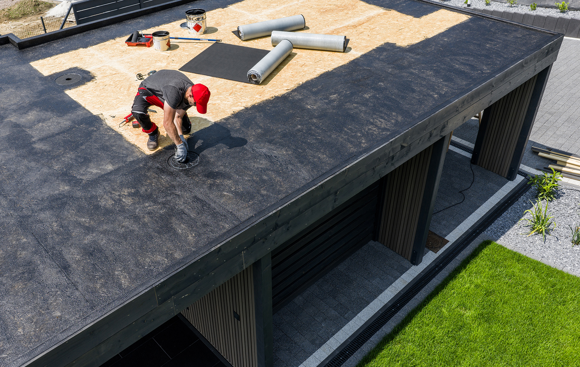 Roofer Applying EPDM Roofing Material Roofer Applying EPDM Roofing Material